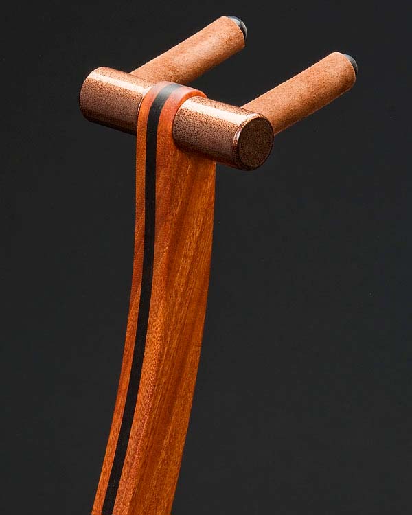 Santos mahogany with ebony inlay. Copper powdercoating.